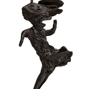 Dark patinated bronze, abstracted image of a lady in a dress with a hat who is caught in the wind. frontside
