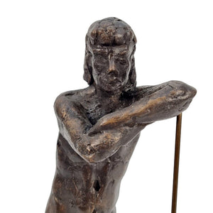 Close-up of a bronze sculpture of a standing male nude leaning on a stick, Height: 30.5 cm. Length: 11 cm. Width: 15.2 cm.