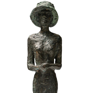 patinated bronze statue of a lady with a hat, close up