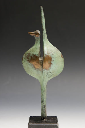 bronze sculpture with green and gilded patina of an abstracted bird, on a rectangular hard stone base. With monogram