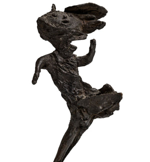 Dark patinated bronze, abstracted image of a lady in a dress with a hat who is caught in the wind. frontside