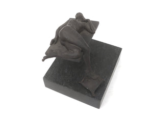 Wim Korink | “Reclining Woman” | Bronze sculpture on natural stone plinth | Total height with plinth 23 cm × width 21 cm × depth 24 cm | Dark patina | A woman rests on one extended foot, horizontal plane, illusion of weightlessness | top view