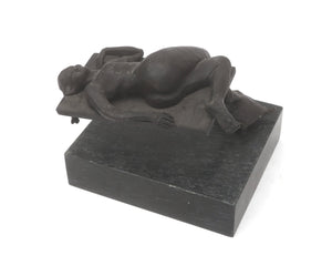 Wim Korink | “Reclining Woman” | Bronze sculpture on natural stone plinth | Total height with plinth 23 cm × width 21 cm × depth 24 cm | Dark patina | A woman rests on one extended foot, horizontal plane, illusion of weightlessness | back view