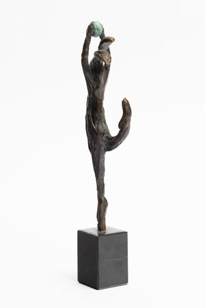 back of bronze statue dancing hare with ball in hand
