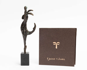 bronze statue of a dancing hare with a ball in hand and a book by the artist